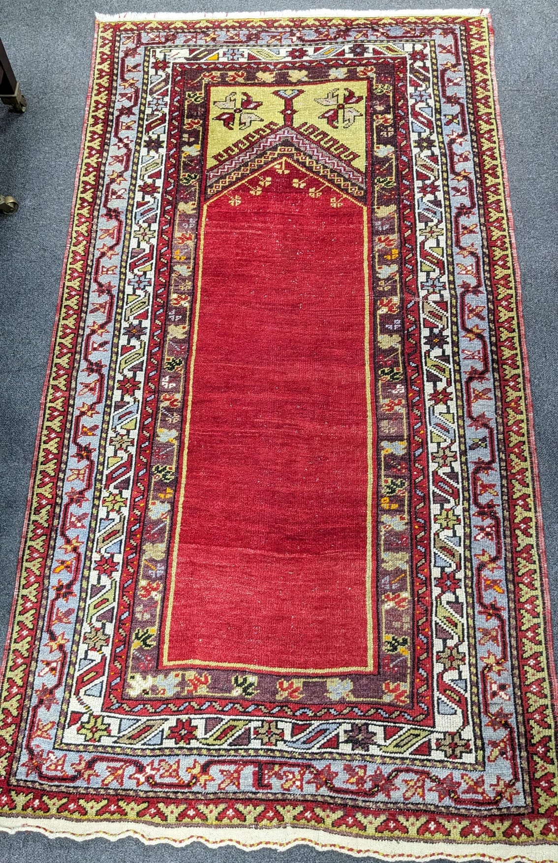 A Kesimuhsine Konya red ground prayer rug, 194 x 104cm